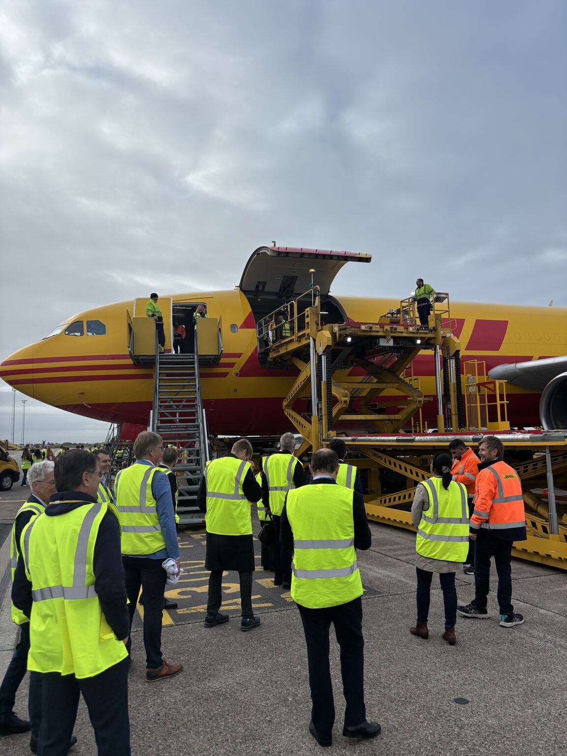 Partecipanti a FlyPharma Copenhagen 2026 davanti a un aereo cargo DHL all’aeroporto di Copenaghen
